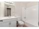 Bathroom with vanity, toilet, and tub-shower combo with white tile surround at 658 S Sycamore St # Value, Mesa, AZ 85202