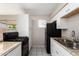 Efficient kitchen featuring white cabinets and black appliances at 658 S Sycamore St # Value, Mesa, AZ 85202