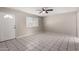 A bright living room featuring neutral walls, a ceiling fan, and white tile flooring at 658 S Sycamore St # Value, Mesa, AZ 85202