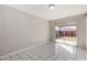 Living room featuring white tile floors, neutral walls, and a sliding glass door to the patio at 658 S Sycamore St # Value, Mesa, AZ 85202