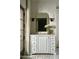 Bathroom vanity featuring white marble counters, a decorative mirror, and a double door to the outside at 6737 E Taza Way, Paradise Valley, AZ 85253