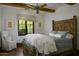 Cozy bedroom with wood floors, a detailed headboard, and a large window with a view at 6737 E Taza Way, Paradise Valley, AZ 85253