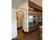 Kitchen featuring a large stainless refrigerator, wood cabinetry, and archway to a pantry at 6737 E Taza Way, Paradise Valley, AZ 85253