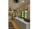 Bright laundry room featuring marble counters, brick floors, and built-in storage beneath a large window at 6737 E Taza Way, Paradise Valley, AZ 85253