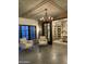 Inviting living room with stone accent wall, comfortable seating, and unique chandelier lighting at 6737 E Taza Way, Paradise Valley, AZ 85253