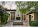 Inviting outdoor living area features a fireplace, comfortable seating, and well manicured landscaping at 6737 E Taza Way, Paradise Valley, AZ 85253