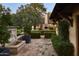 View of the outdoor patio with fountain and an outdoor seating area surrounded by lush landscaping at 6737 E Taza Way, Paradise Valley, AZ 85253