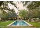 Stunning pool with a fountain feature, surrounded by lush landscaping and manicured lawns at 6737 E Taza Way, Paradise Valley, AZ 85253