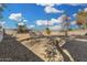 Spacious backyard featuring a gravel ground cover, block wall fencing, and a sunny Arizona sky at 7022 N 26Th Dr, Phoenix, AZ 85051