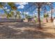 Gravel-covered backyard featuring a secure block wall fence and mature trees, perfect for desert landscaping at 7022 N 26Th Dr, Phoenix, AZ 85051