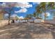 Expansive backyard showcasing the home's exterior, gravel ground cover, and secure block wall fencing at 7022 N 26Th Dr, Phoenix, AZ 85051