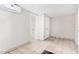 This bedroom features light gray walls and tile floors with a view of the bath at 7022 N 26Th Dr, Phoenix, AZ 85051