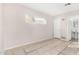 Bedroom featuring tiled floors, a window, and a bathroom entrance at 7022 N 26Th Dr, Phoenix, AZ 85051