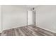 Neutral bedroom featuring gray laminate flooring, fresh paint, and closet at 7022 N 26Th Dr, Phoenix, AZ 85051