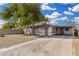 Single story home with mature trees, a carport, and low-maintenance landscaping at 7022 N 26Th Dr, Phoenix, AZ 85051