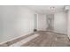 Neutral-toned living room with doorways into adjacent rooms and unfinished flooring at 7022 N 26Th Dr, Phoenix, AZ 85051