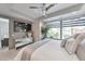 Relaxing bedroom with modern decor, a mirrored dresser, and a large window offering an abundance of natural light at 7151 E Rancho Vista Dr # 2007, Scottsdale, AZ 85251