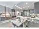 Open-concept kitchen and dining area with modern gray cabinets, stainless appliances, and elegant lighting at 7151 E Rancho Vista Dr # 2007, Scottsdale, AZ 85251