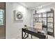 Bright home office featuring modern shelving and a desk, complemented by stylish artwork and ample lighting at 7151 E Rancho Vista Dr # 2007, Scottsdale, AZ 85251