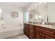 Relaxing bathroom offers dual sinks, a soaking tub, and custom cabinetry at 7611 S 15Th St, Phoenix, AZ 85042