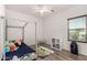 Cozy bedroom features a canopy bed, a ceiling fan, and a window with blinds at 7611 S 15Th St, Phoenix, AZ 85042