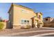 View of two-story home featuring neutral color scheme, desert landscaping, and two car garage at 7611 S 15Th St, Phoenix, AZ 85042