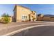 Two-story home featuring neutral color scheme, desert landscaping, and two car garage at 7611 S 15Th St, Phoenix, AZ 85042