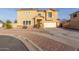 Two-story home featuring a two car garage, neutral color scheme, and desert landscaping at 7611 S 15Th St, Phoenix, AZ 85042