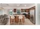 Well-equipped kitchen with island, granite countertops, and stainless steel appliances, adjacent to the dining area at 7611 S 15Th St, Phoenix, AZ 85042