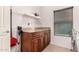 Laundry room featuring wood cabinets, granite countertops, and front-load washer at 7611 S 15Th St, Phoenix, AZ 85042