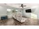 Living room with ceiling fan, light walls, and wood-look floors at 7611 S 15Th St, Phoenix, AZ 85042