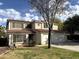 Charming two-story home showcasing a three car garage and a shade tree at 765 S Ruby Pl, Gilbert, AZ 85296