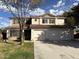 Charming two-story home showcasing a three car garage and green grass at 765 S Ruby Pl, Gilbert, AZ 85296