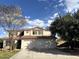 Charming two-story home showcasing a three car garage and red tile roof at 765 S Ruby Pl, Gilbert, AZ 85296