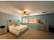 This is a spacious main bedroom with light blue walls, wood blinds, and a ceiling fan at 765 S Ruby Pl, Gilbert, AZ 85296