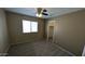 Bedroom boasts carpet, ceiling fan, and closet space for comfort and functionality at 8014 W Beaubien Dr, Peoria, AZ 85382