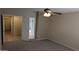 Neutral bedroom showcasing a ceiling fan and doorways leading to other rooms at 8014 W Beaubien Dr, Peoria, AZ 85382