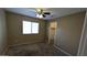 Bedroom featuring neutral paint, carpet, ceiling fan, and window offering natural light at 8014 W Beaubien Dr, Peoria, AZ 85382