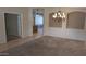 Spacious dining room showcasing a chandelier and doorway to another room at 8014 W Beaubien Dr, Peoria, AZ 85382