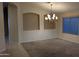 Dining room featuring a chandelier, beige walls, and a carpeted floor at 8014 W Beaubien Dr, Peoria, AZ 85382