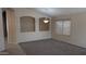 Bright living room features neutral walls, plush carpet, and elegant chandelier, creating a welcoming ambiance at 8014 W Beaubien Dr, Peoria, AZ 85382