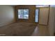 Neutral-toned living room featuring large window and light colored walls at 8014 W Beaubien Dr, Peoria, AZ 85382