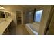 Main bathroom with double sinks, vanity with cabinets, and a soaking tub and glass shower at 8014 W Beaubien Dr, Peoria, AZ 85382