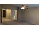 Main bedroom with carpet, neutral paint, ceiling fan and views into the main bathroom at 8014 W Beaubien Dr, Peoria, AZ 85382