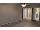 Main bedroom with carpet, neutral paint, ceiling fan and views into the main bathroom at 8014 W Beaubien Dr, Peoria, AZ 85382