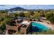 Aerial view of community pool surrounded by lush desert landscaping at 8502 E Cave Creek Rd # 10, Carefree, AZ 85377