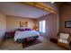 Comfortable bedroom with southwest decor, natural light, and ceiling beams at 8502 E Cave Creek Rd # 10, Carefree, AZ 85377