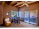 Bright bedroom featuring vaulted ceilings, a ceiling fan, and sliding glass doors at 8502 E Cave Creek Rd # 10, Carefree, AZ 85377