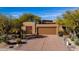 Beautiful home featuring a neutral stucco finish, attached two-car garage, and mature desert landscaping at 8502 E Cave Creek Rd # 10, Carefree, AZ 85377