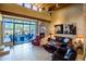 Bright living room featuring a cozy fireplace, leather furniture, and a sliding door to the outdoor space at 8502 E Cave Creek Rd # 10, Carefree, AZ 85377